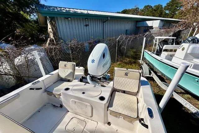 Slide: The Image of 2023 Carolina Skiff 21 LS boat with seating and motor, parked outdoors. - 20