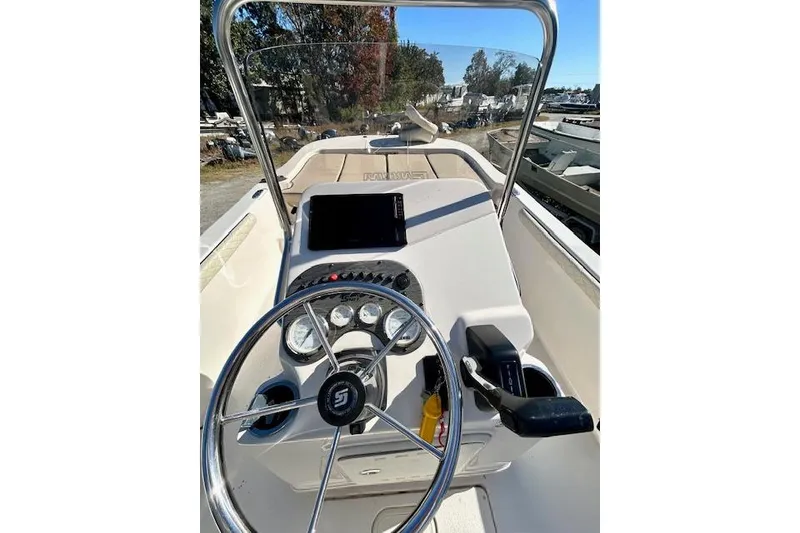 Slide: The Image of 2023 Carolina Skiff 21 LS boat dashboard with steering wheel and controls. - 25