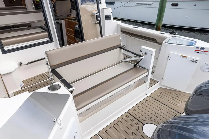 Slide: The Image of 2025 Cutwater C-288 Coupe LE boat interior with seating and wood flooring. - 10