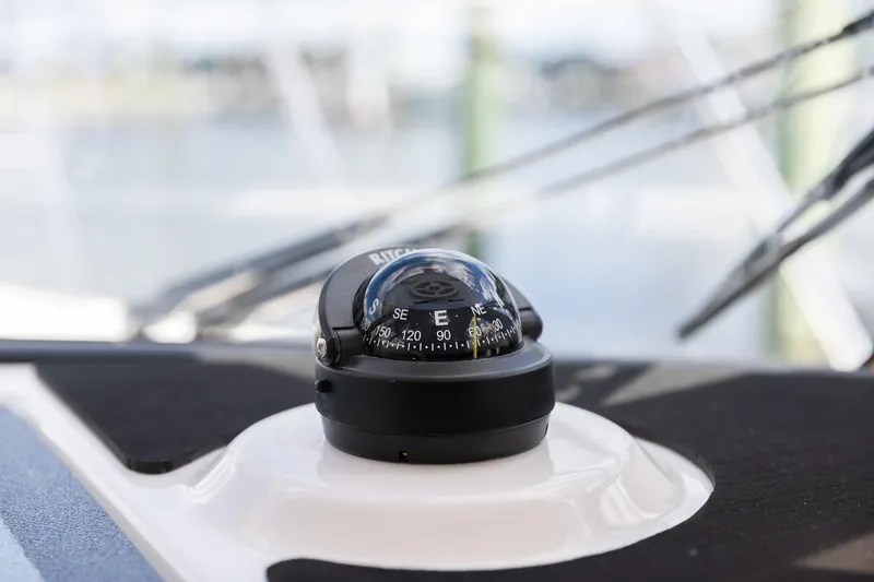 Slide: The Image of Compass on 2025 Cutwater C-288 Coupe LE boat dashboard. - 15