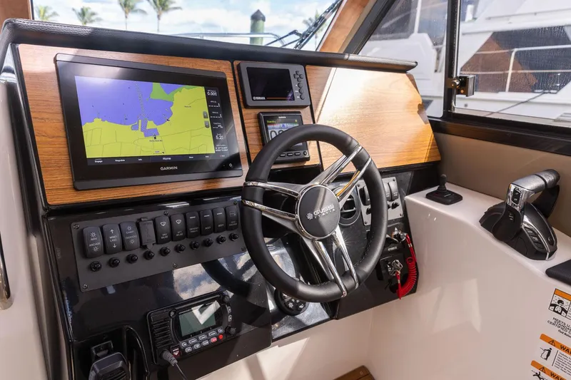 Slide: The Image of 2025 Cutwater C-288 Coupe LE helm with navigation display and steering wheel. - 21