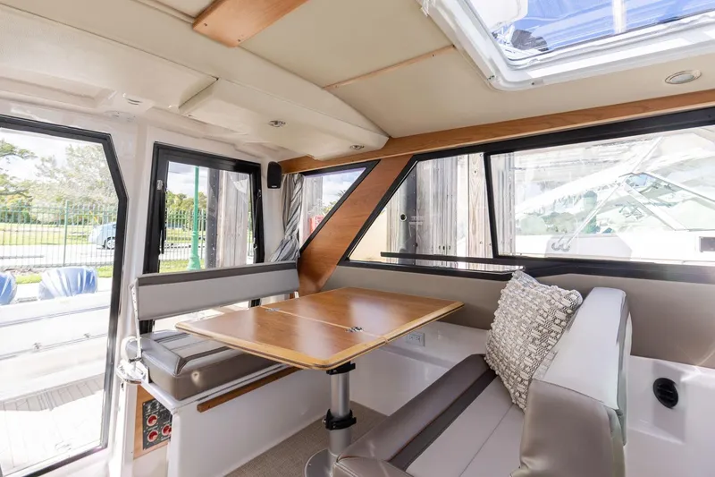 Slide: The Image of Interior of 2025 Cutwater C-288 Coupe LE with modern seating and table. - 23