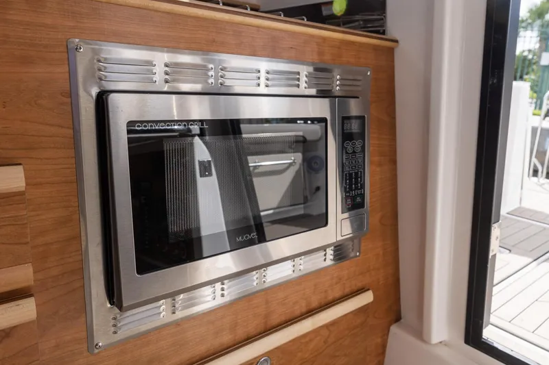 Slide: The Image of Built-in microwave in 2025 Cutwater C-288 Coupe LE boat interior. - 24