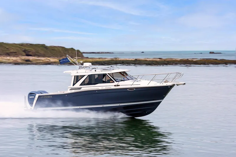 Slide: The Image of 2025 Cutwater C-288 Coupe LE cruising on calm waters. - 4
