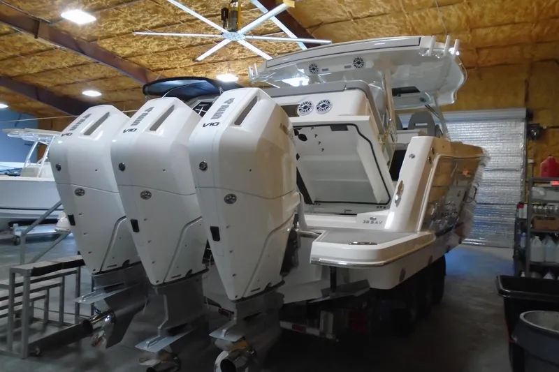 Slide: The Image of 2026 Regal 38 SAV boat on trailer in indoor showroom setting. - 1