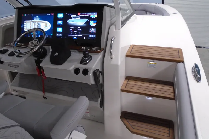 Slide: The Image of 2026 Regal 38 SAV boat helm with advanced navigation displays and wooden steps. - 21