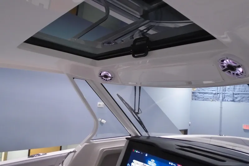 Slide: The Image of Interior view of 2026 Regal 38 SAV boat with sunroof and speakers. - 22