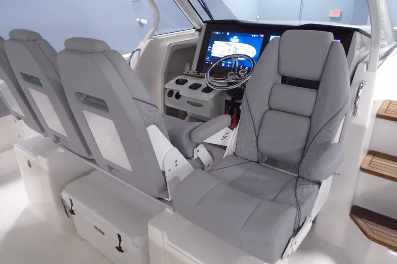 Slide: The Image of 2026 Regal 38 SAV boat cockpit with modern controls and comfortable seating. - 23