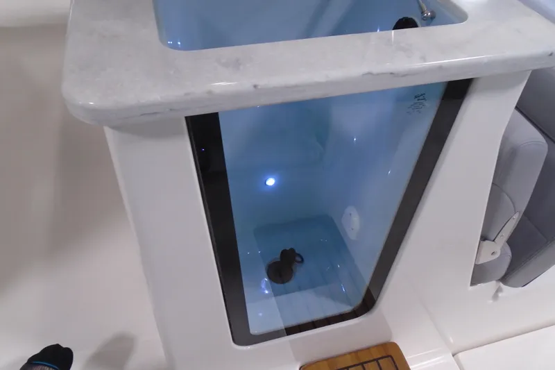 Slide: The Image of Livewell compartment on 2026 Regal 38 SAV boat, featuring a sleek design and interior lighting. - 27