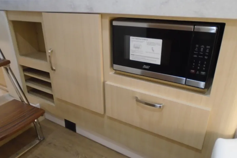 Slide: The Image of Built-in microwave and cabinetry in 2026 Regal 38 SAV boat interior. - 35