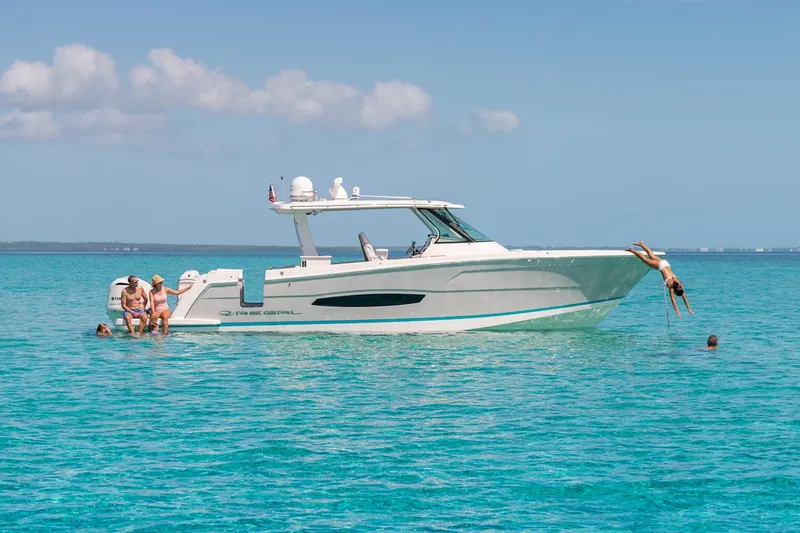 Slide: The Image of 2026 Regal 38 SAV boat with triple Mercury engines in a showroom. - 5