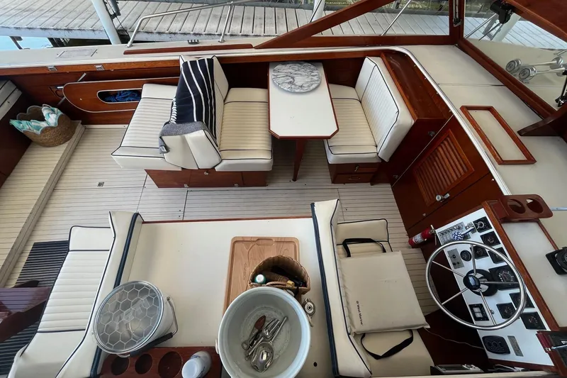 Slide: The Image of 1984 Skiff Craft 26 Runabout interior with seating, table, and steering wheel. - 11