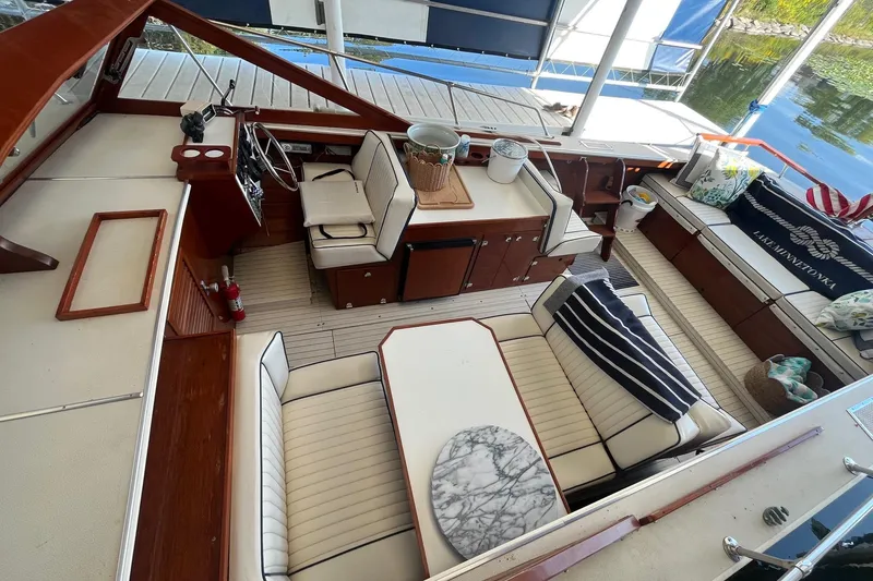 Slide: The Image of 1984 Skiff Craft 26 Runabout interior with elegant seating and wooden accents. - 12
