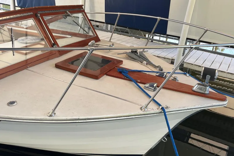 Slide: The Image of 1984 Skiff Craft 26 Runabout boat with wooden accents and blue rope on deck. - 2