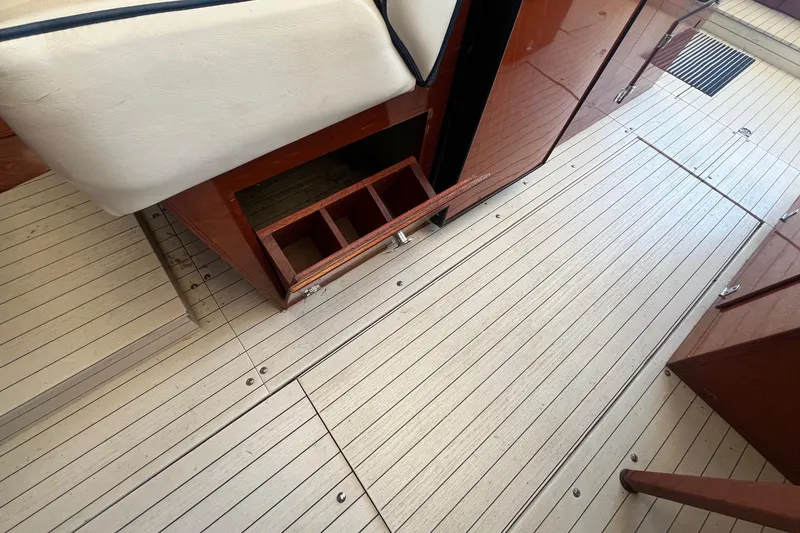 Slide: The Image of 1984 Skiff Craft 26 Runabout interior with wooden flooring and storage compartments. - 21