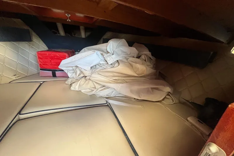 Slide: The Image of Interior of 1984 Skiff Craft 26 Runabout with cushions and storage items. - 22