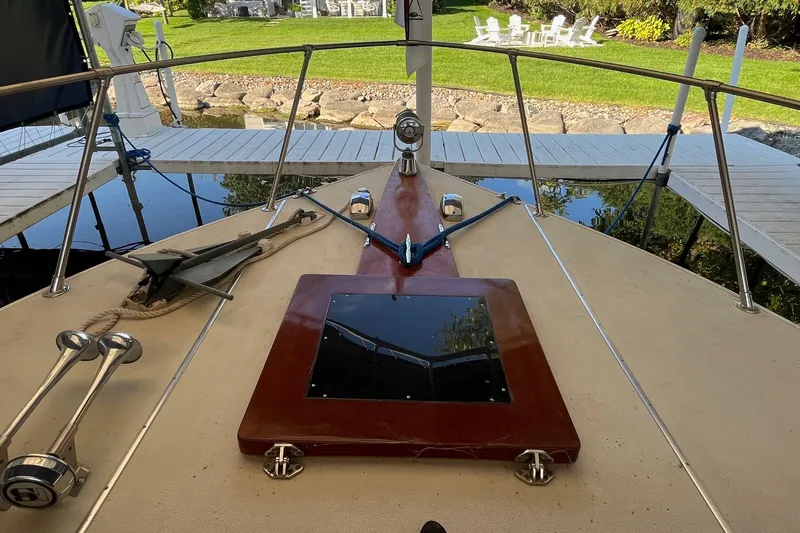 Slide: The Image of 1984 Skiff Craft 26 Runabout boat deck with anchor and dock view. - 24