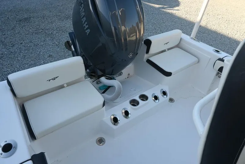 Slide: The Image of 2026 Tidewater 198 CC Adventure boat interior with Yamaha engine, white seating, and cup holders. - 10