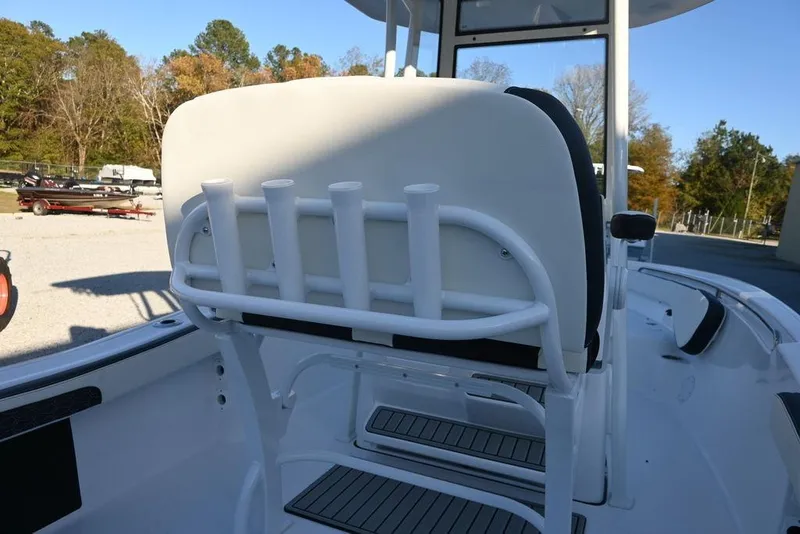 Slide: The Image of 2026 Tidewater 198 CC Adventure boat interior with rod holders and seating. - 13