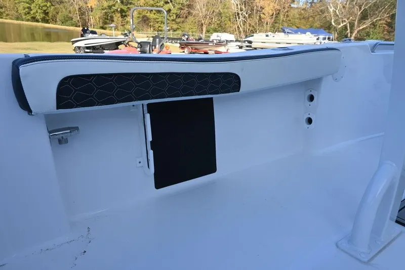 Slide: The Image of 2026 Tidewater 198 CC Adventure boat interior detail with cushioned seating and storage compartment. - 15