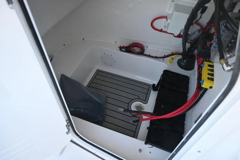 Slide: The Image of Interior view of 2026 Tidewater 198 CC Adventure boat's storage compartment with wiring. - 17