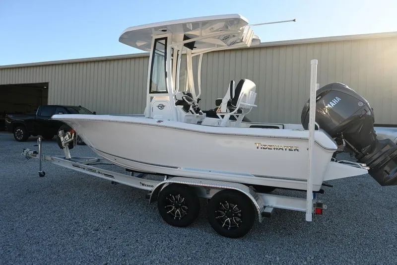 Slide: The Image of 2026 Tidewater 198 CC Adventure boat on trailer, parked outdoors. - 9