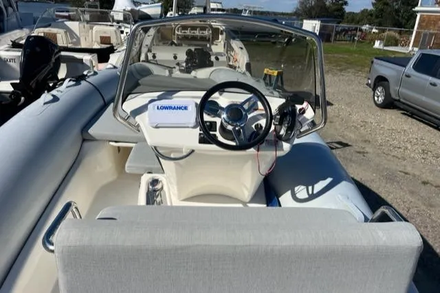 Slide: The Image of 2023 Zodiac N-ZO 680 boat cockpit with steering wheel and Lowrance navigation system. - 12