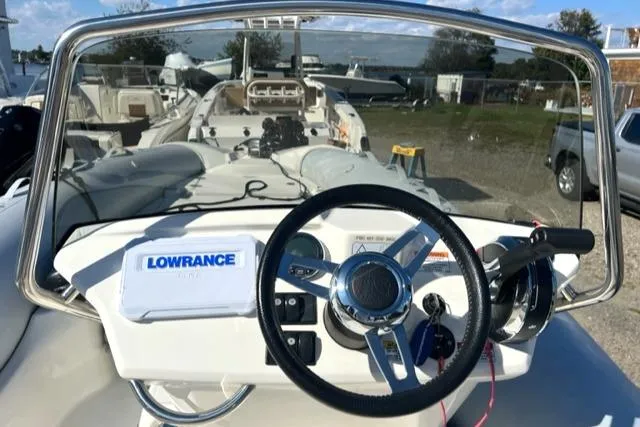 Slide: The Image of 2023 Zodiac N-ZO 680 boat dashboard with steering wheel and Lowrance navigation system. - 13