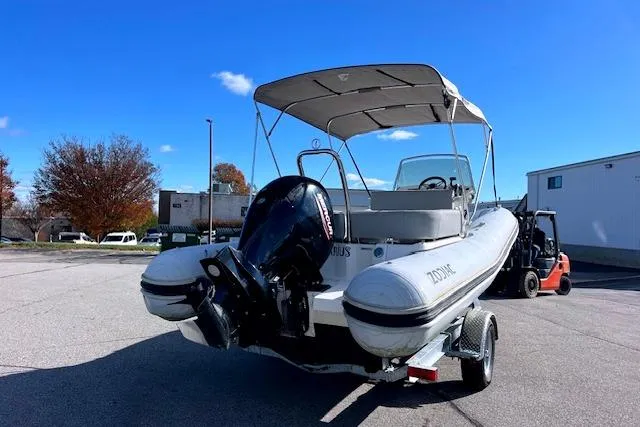 Slide: The Image of 2023 Zodiac N-ZO 680 boat with canopy and outboard motor on a trailer. - 2