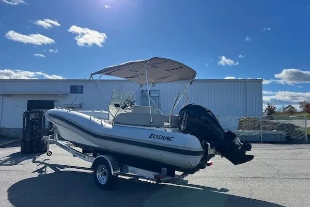 Slide: The Image of 2023 Zodiac N-ZO 680 boat on trailer, parked outdoors under clear blue sky. - 3