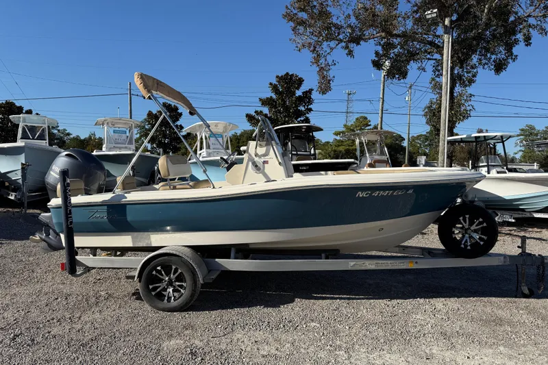 Slide: The Image of 2016 Pioneer 180 Islander boat on trailer, parked outdoors under clear sky. - 3