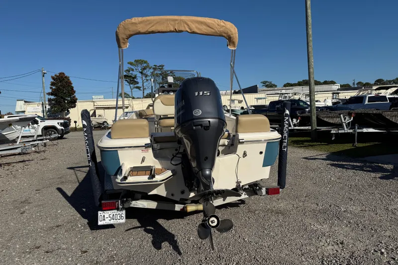 Slide: The Image of 2016 Pioneer 180 Islander boat with Yamaha 115 engine, parked on gravel lot. - 6
