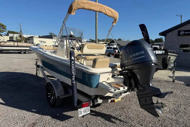 Slide: The Image of 2016 Pioneer 180 Islander boat with Yamaha engine on trailer in a marina. - 7