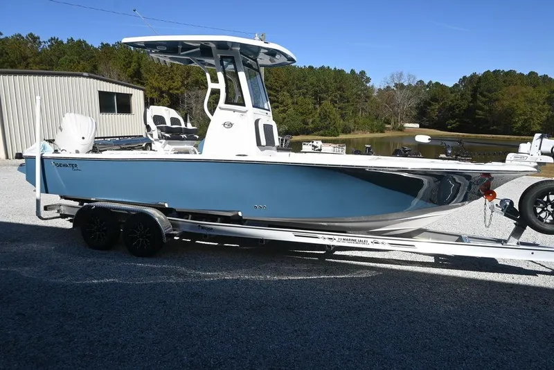 The Image of 2026 Tidewater 2500 Carolina Bay boat on trailer, parked outdoors near a pond. - 1