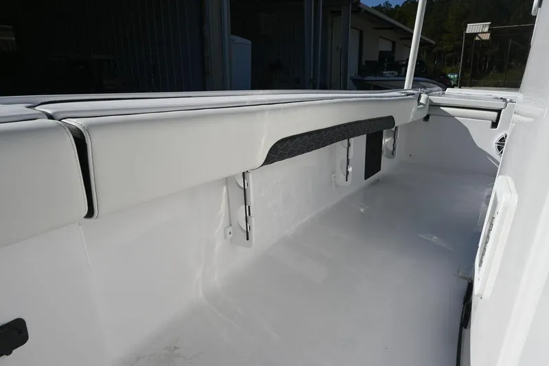 Slide: The Image of 2026 Tidewater 2500 Carolina Bay boat interior with sleek white seating and storage compartments. - 10