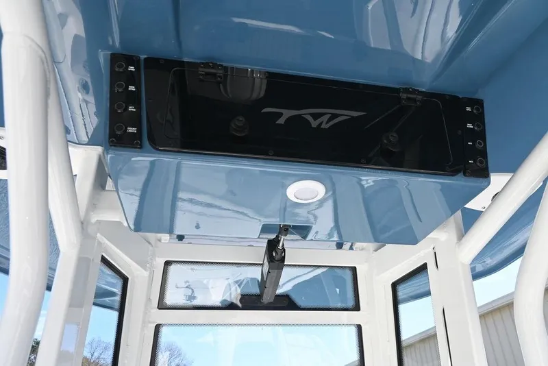 Slide: The Image of 2026 Tidewater 2500 Carolina Bay boat interior with blue console and control panel. - 11