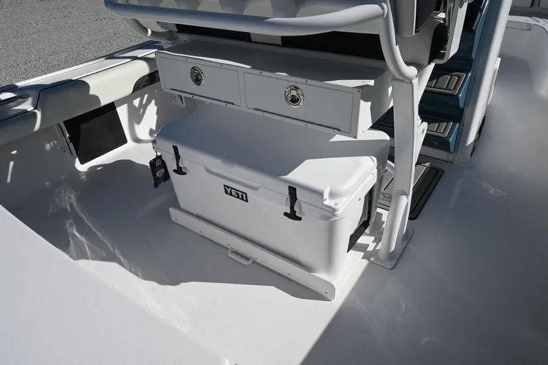 Slide: The Image of 2026 Tidewater 2500 Carolina Bay boat interior with Yeti cooler and storage drawers. - 17