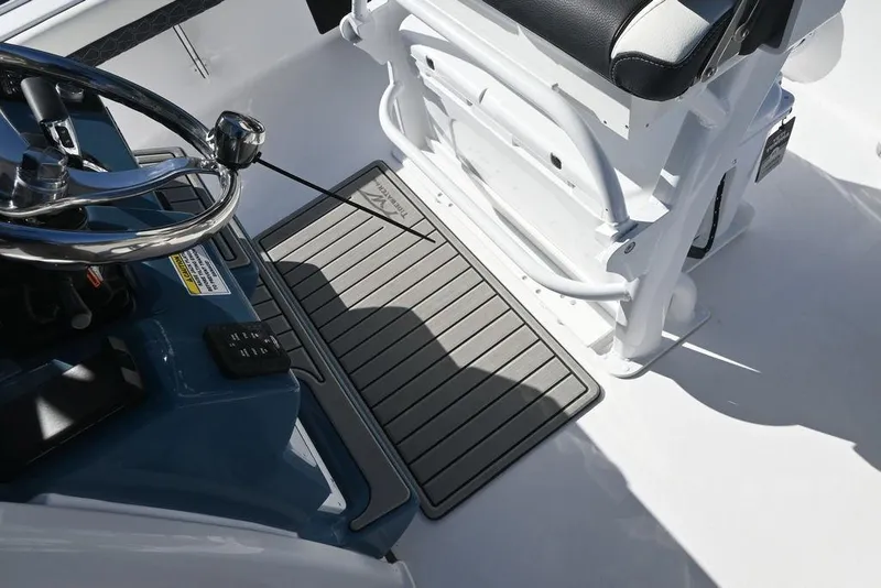 Slide: The Image of 2026 Tidewater 2500 Carolina Bay boat interior with steering wheel and seating area. - 19