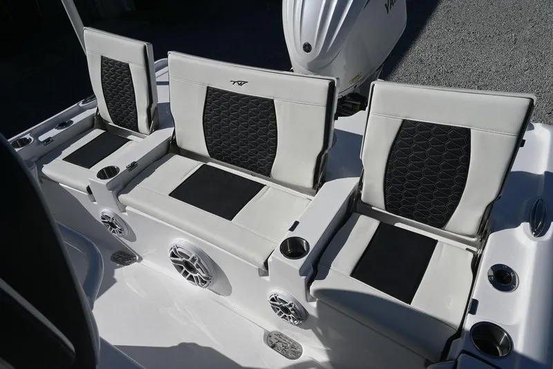 Slide: The Image of 2026 Tidewater 2500 Carolina Bay boat seats with black and white upholstery, cup holders, and speakers. - 20