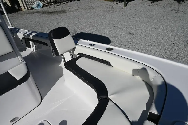 Slide: The Image of 2026 Tidewater 2500 Carolina Bay boat interior with cushioned seating and cup holders. - 23