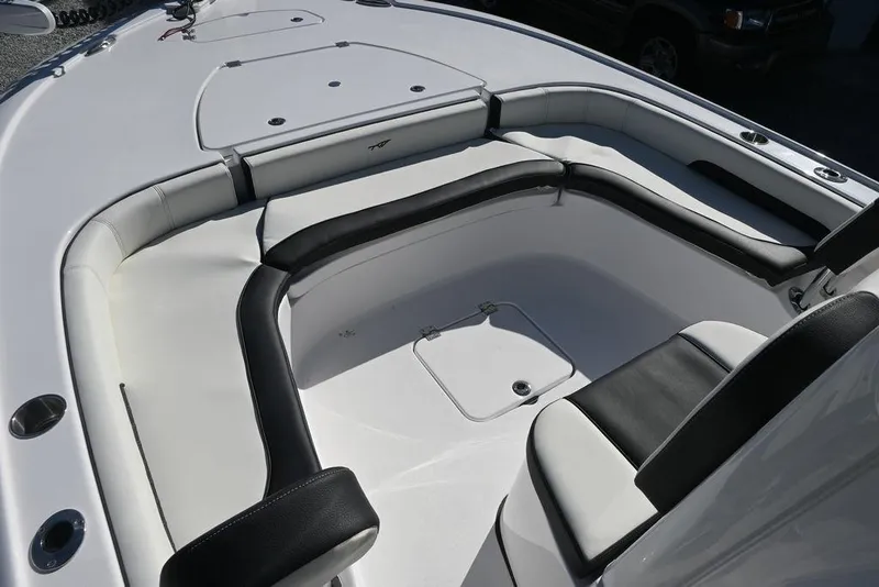 Slide: The Image of 2026 Tidewater 2500 Carolina Bay boat interior with cushioned seating and storage compartments. - 24