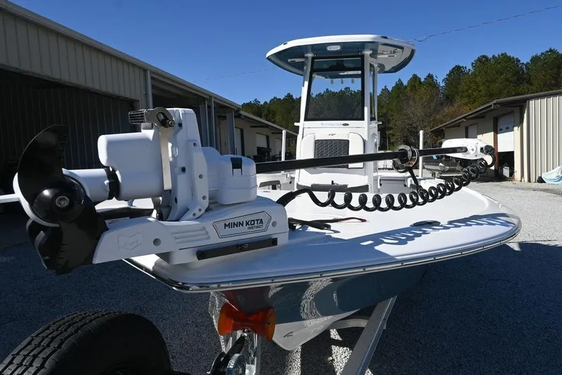 Slide: The Image of 2026 Tidewater 2500 Carolina Bay boat with Minn Kota motor, parked outdoors. - 6