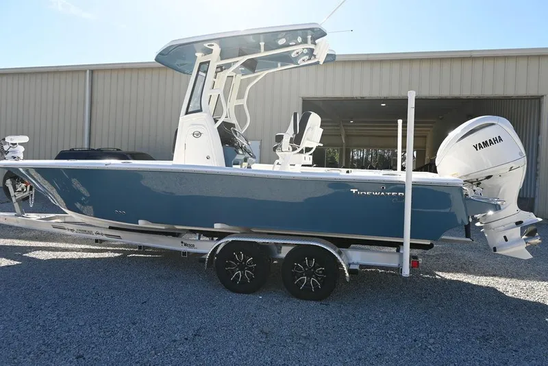 Slide: The Image of 2026 Tidewater 2500 Carolina Bay boat with Yamaha engine on trailer, parked outside a building. - 7