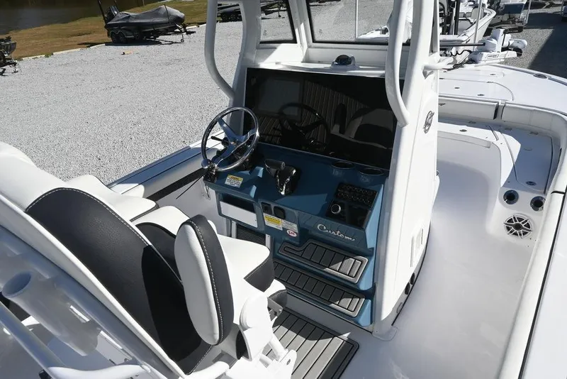 Slide: The Image of 2026 Tidewater 2500 Carolina Bay boat interior with steering console and seating. - 8