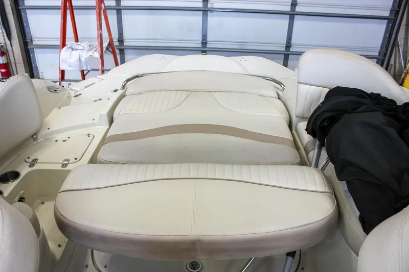 Slide: The Image of Interior of a 2007 Azure AZ228 boat with beige seating and storage compartments. - 11