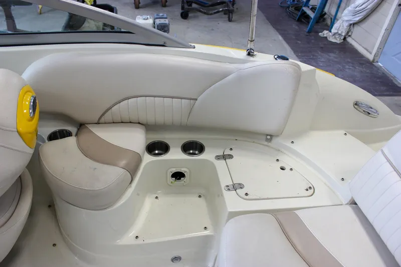 Slide: The Image of Interior of a 2007 Azure AZ228 boat with beige seating and cup holders. - 12