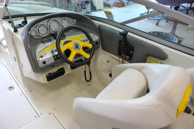 Slide: The Image of 2007 Azure AZ228 boat cockpit with yellow steering wheel and white seating. - 13