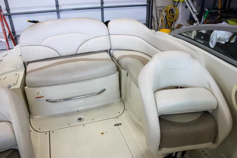 Slide: The Image of 2007 Azure AZ228 boat interior with white and beige seating in a garage setting. - 14