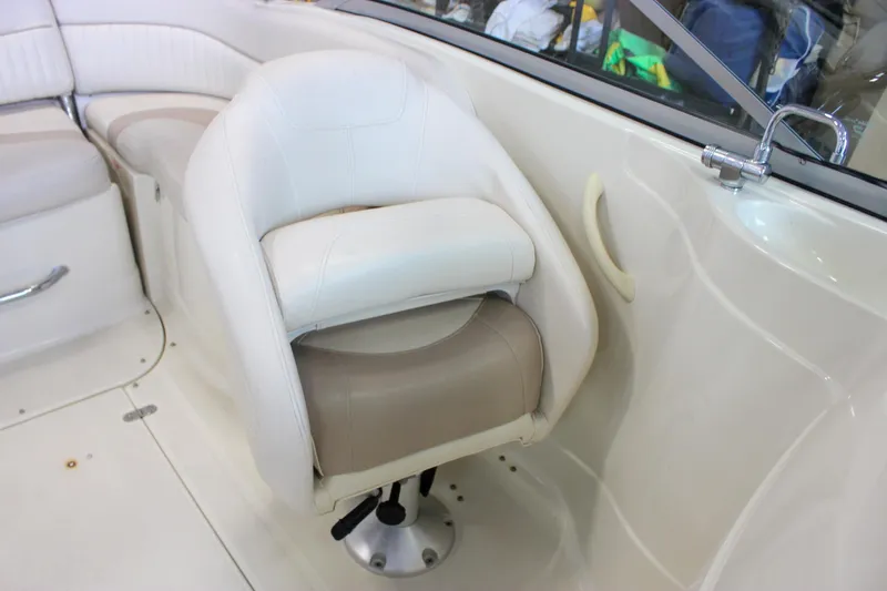 Slide: The Image of Captain's seat in 2007 Azure AZ228 boat, featuring white and beige upholstery. - 15