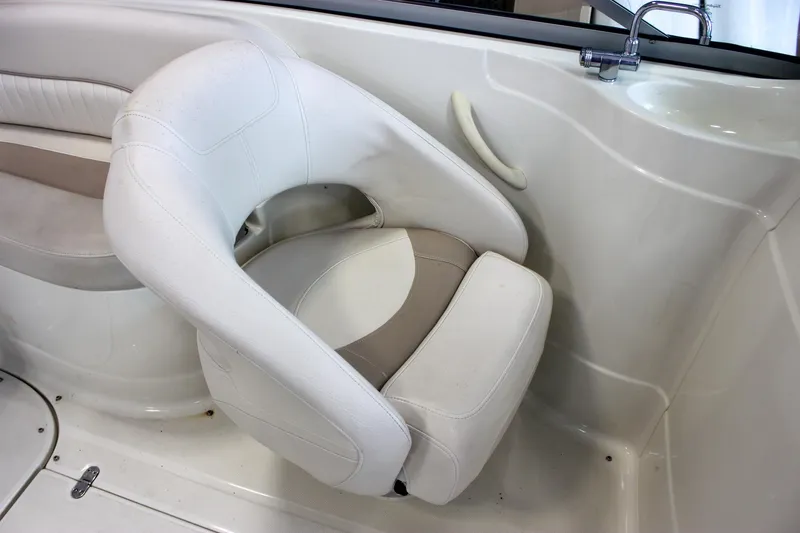 Slide: The Image of White interior seating of 2007 Azure AZ228 boat, featuring a swivel chair and grab handle. - 16